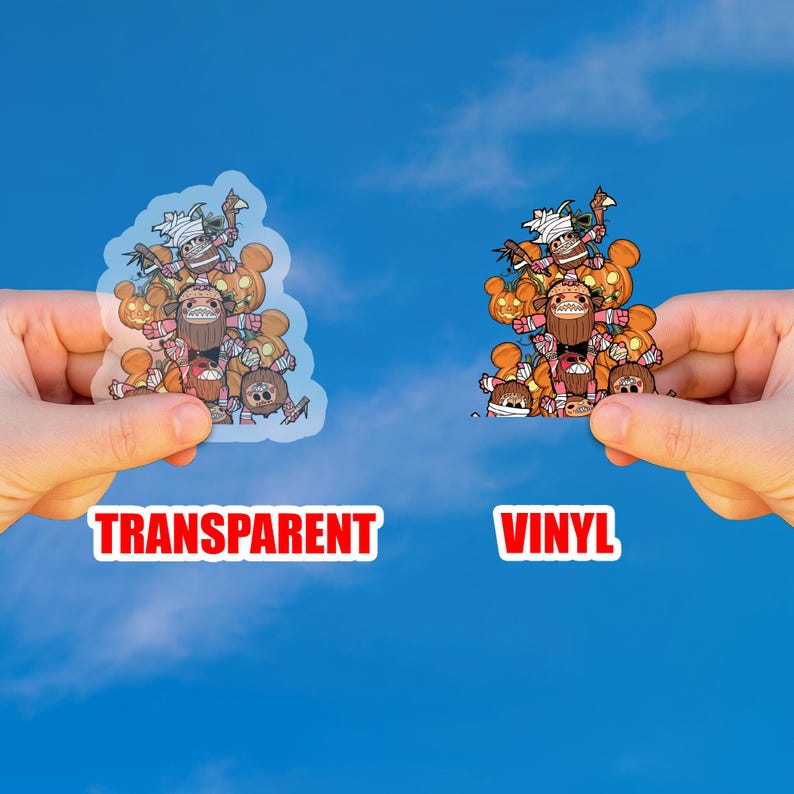 May include: Two stickers, one transparent and one vinyl, featuring a cartoon design of a group of characters with pumpkin and Halloween themes. The word "TRANSPARENT" is printed in red on the left, and "VINYL" is printed in red on the right.