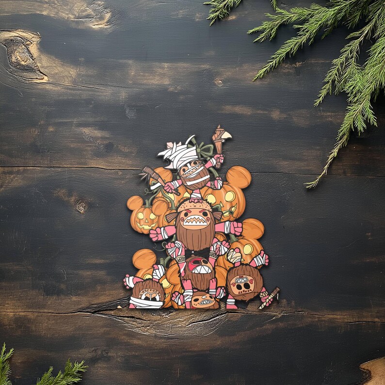 May include: A stack of Halloween-themed character cutouts with pumpkin and monster designs. The characters are in shades of brown, pink, and white, with orange pumpkin accents. The background is a dark wood surface with green foliage.