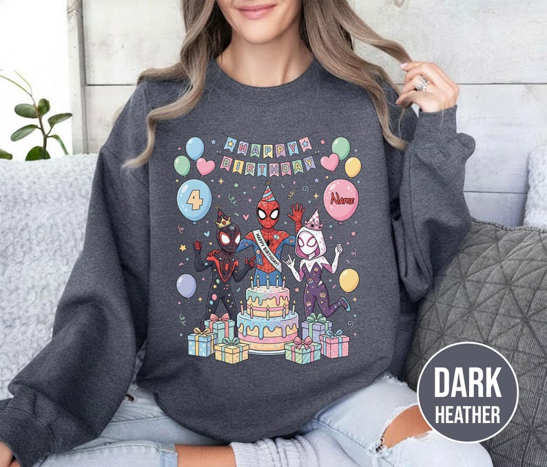 May include: Dark heather gray sweatshirt featuring a colorful birthday design. The graphic includes Spider-Man characters, a cake, balloons, and the words "Happy Birthday." The number "4" is on a balloon. Several wrapped gifts are at the bottom.