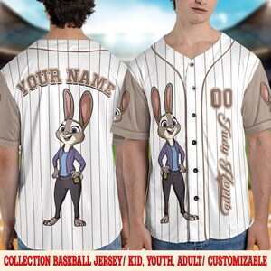 May include: White baseball jersey with brown pinstripes, featuring a cartoon rabbit character. The jersey has the text "YOUR NAME" on the back and "Judy Hopps" on the front. The sleeves are brown, and the jersey has black buttons.