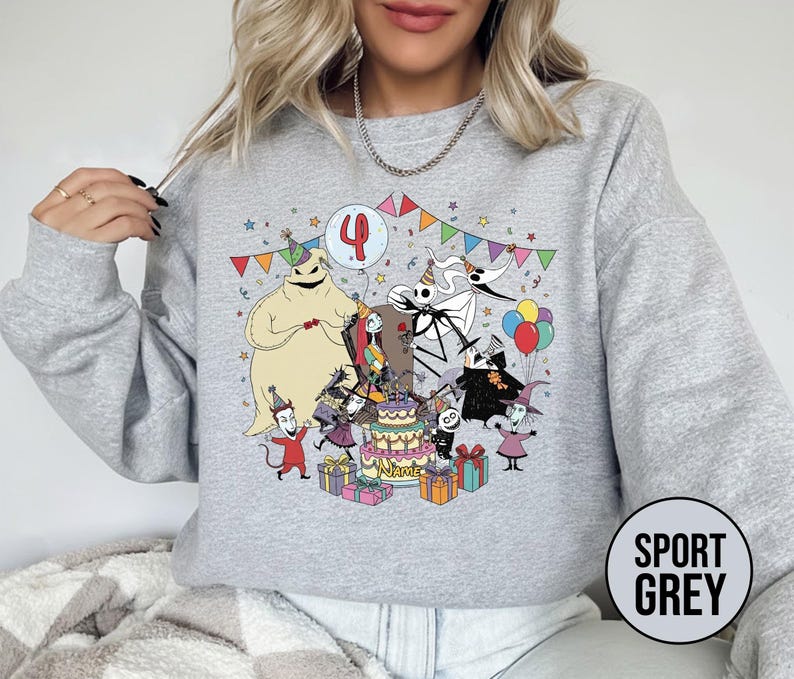 May include: Sport grey sweatshirt featuring a colorful graphic of characters from The Nightmare Before Christmas celebrating a birthday. The design includes a cake, presents, and the number 4. The sweatshirt has long sleeves and a crew neck.