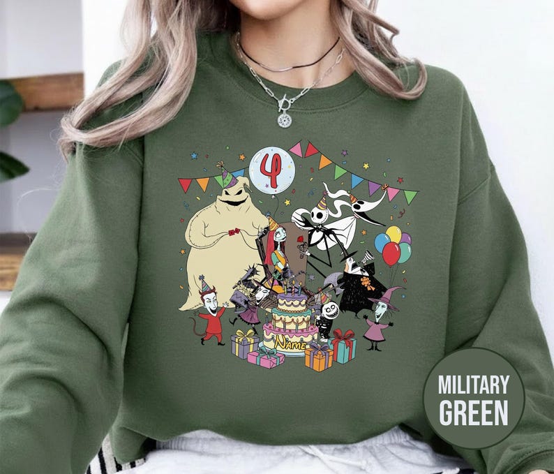 May include: Military green sweatshirt featuring a colorful graphic of characters from The Nightmare Before Christmas celebrating a birthday. The design includes a cake, balloons, and the number 4. The word "NAME" is on the cake.