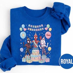 May include: Royal blue sweatshirt featuring a colorful birthday design with Spider-Man characters. The graphic includes a cake, balloons, and the text "Happy Birthday." The number "4" is displayed on a balloon, suggesting a fourth birthday celebration.