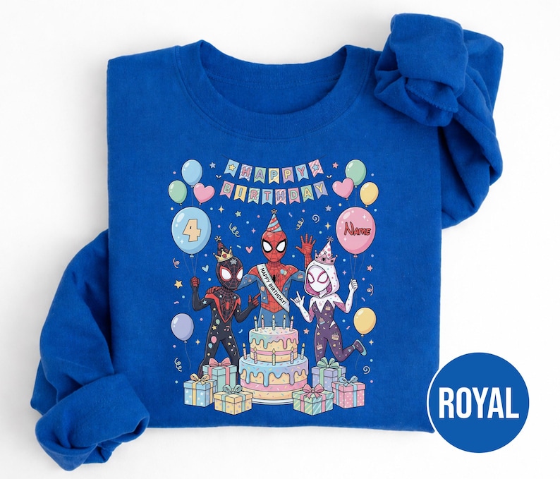 May include: Royal blue sweatshirt featuring a colorful birthday design with Spider-Man characters. The graphic includes a cake, balloons, and the text "Happy Birthday." The number "4" is displayed on a balloon, suggesting a fourth birthday celebration.