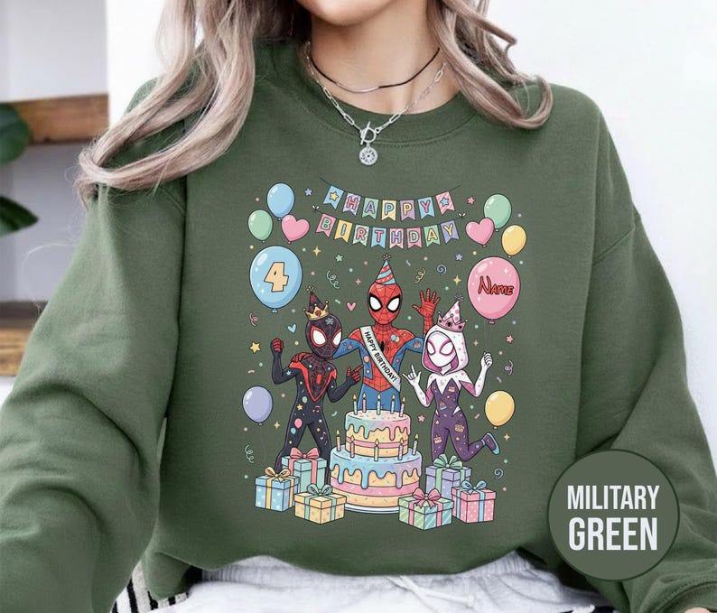 May include: Military green sweatshirt featuring a colorful graphic of Spider-Man characters celebrating a birthday. The design includes a cake, balloons, and the text "Happy Birthday". The number "4" is also displayed.
