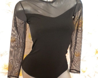 May include: Black long-sleeved bodysuit with a sheer mesh overlay on the neckline and sleeves.