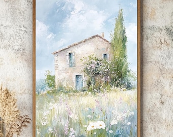 Puede incluir: Un cuadro enmarcado que representa una casa de piedra con puerta y contraventanas azules, rodeada por un campo de flores silvestres blancas y moradas bajo un cielo azul claro. Un alto ciprés verde se alza junto a la casa de acabado texturizado.