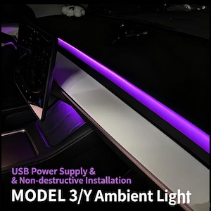 May include: A purple LED ambient light strip installed along the dashboard of a vehicle. The text on the image reads: USB Power Supply & Non-destructive Installation MODEL 3/Y Ambient Light. The light emits a vibrant purple glow across the interior.