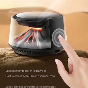 May include: A black and clear fragrance diffuser featuring a volcano or ice mountain landscape display. Text includes: A touch transforms the world and makes the house smell good. One finger touch for intensity, double tap to switch scenery.