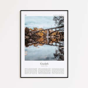 May include: Framed print showing a bridge over a river with autumn colours. The print includes the city name "Guelph" and coordinates, with a black border. The image is a landscape.