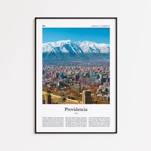 May include: A framed print featuring a vibrant aerial view of a city with a backdrop of snow-capped mountains under a clear blue sky. The print includes the name "Providencia" and descriptive text at the bottom.