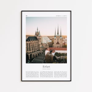 May include: Framed print featuring a scenic view of Erfurt, Germany, showcasing the city's architecture. The image captures the cathedral and other historic buildings under a bright sky. The print is in a black frame.