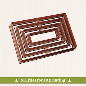 May include: A set of four nested rectangular cookie cutters in a copper-toned finish. The cutters are arranged one inside the other, featuring a simple frame design. A green banner at the bottom contains the text: STL files for 3D printing.