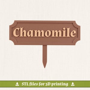 May include: A brown garden plant marker with a rectangular shape and decorative scalloped edges. The word Chamomile is embossed in a lighter tan color across the center. A single pointed stake extends from the bottom center of the sign.