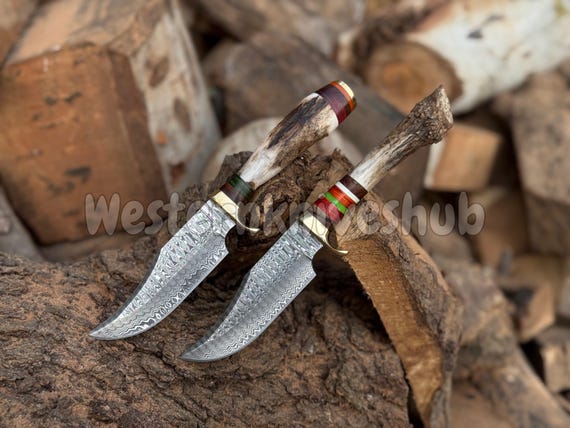 A full Damascus steel knife set with genuine stag/elk antler handles and leather sheaths — every piece is a functional heirloom forged by hand.