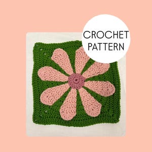 May include: A square crochet pattern featuring a large flower design. The flower has pink petals and a darker pink center, set against a green square background. The text "CROCHET PATTERN" is in a white circle.