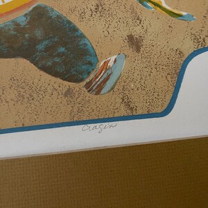 May include: A colorful abstract print with a blue, yellow, and orange design. The print is signed "Craigin" and numbered "9/15".