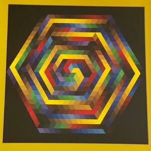 May include: Geometric abstract art print featuring a colorful hexagonal design. The artwork showcases a spiral pattern within the hexagon, with a palette of yellow, red, blue, green, and brown hues against a black background, framed in yellow.