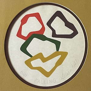 May include: A framed print of an abstract art piece with four overlapping shapes in red, green, purple, and yellow. The print is titled "Falling" and signed "Susan Kohl" with the number "8/29" in the bottom left corner.