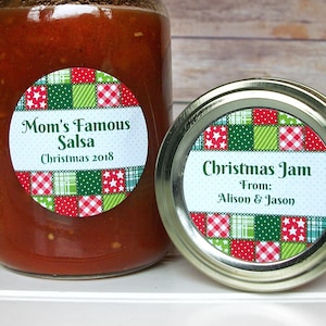 May include: Two round jar labels with a red, green, and white patchwork design. The label on the left says "Mom's Famous Salsa Christmas 2018". The label on the right says "Christmas Jam From: Alison & Jason".