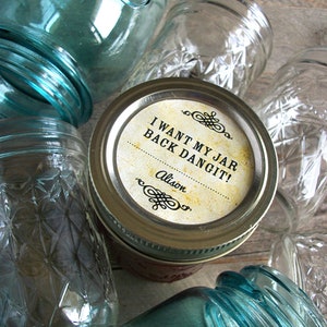 May include: A collection of glass jars with a label on one jar that reads "I want my jar back dangit! Alison".