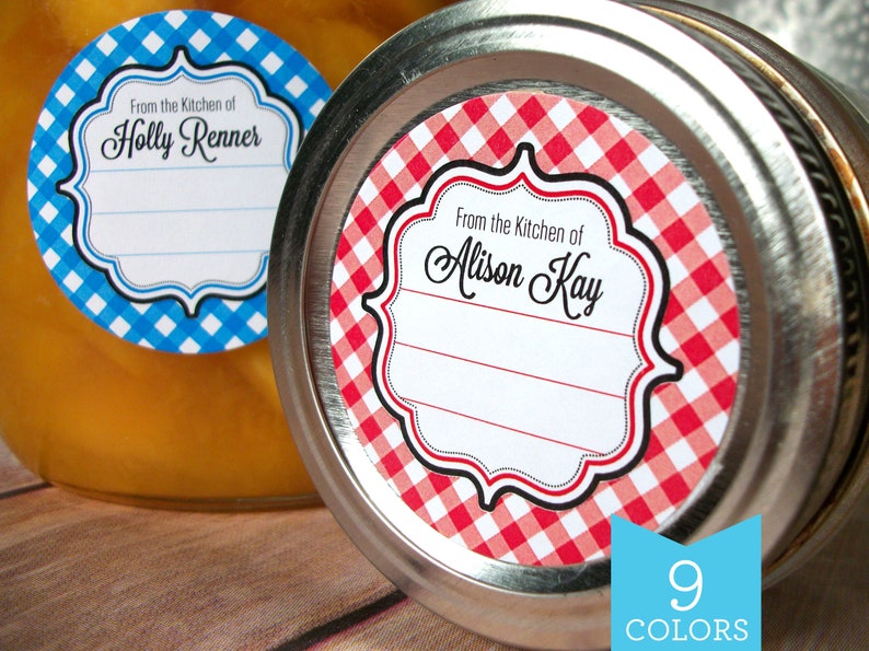 May include: Two round jar labels with a gingham pattern. The label on the left is blue and white and says "From the Kitchen of Holly Renner". The label on the right is red and white and says "From the Kitchen of Alison Kay".