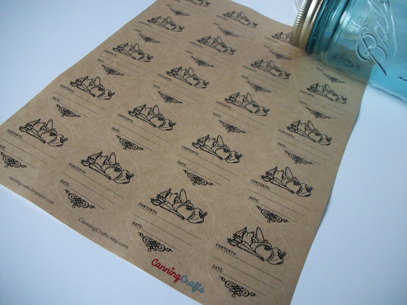 May include: A sheet of brown paper with round, white, sticker labels. Each label has a black and white illustration of vegetables and the words "CONTENTS" and "DATE" with blank lines for writing.