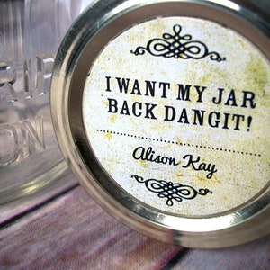 May include: A white jar lid with a brown label that says "I want my jar back dangit!" and "Alison Kay" in black text. The label has a decorative design at the top and bottom.