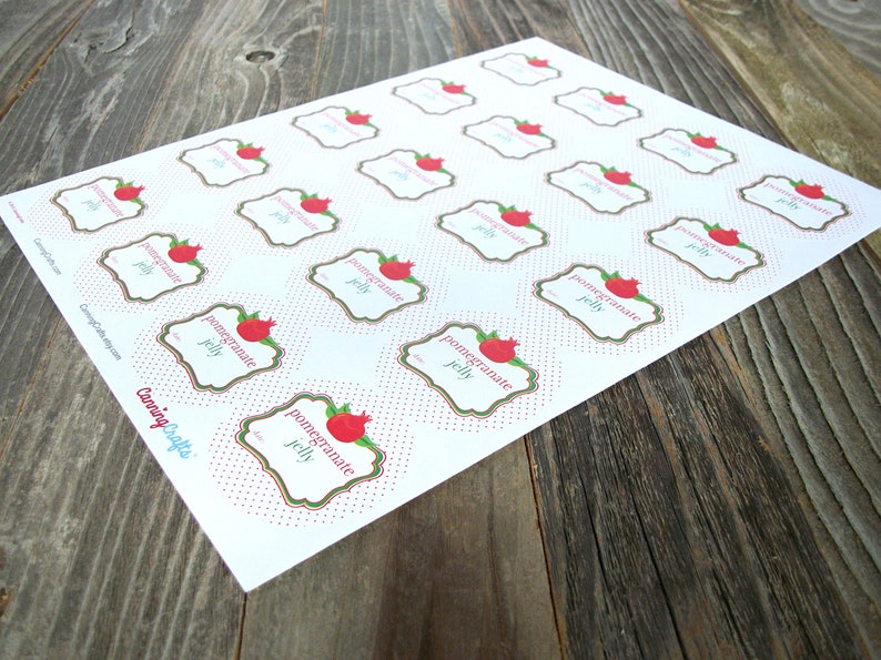 May include: Printable sheet of 20 white labels with red polka dots. Each label features a green and gold frame with a red pomegranate illustration and the text "pomegranate jelly".