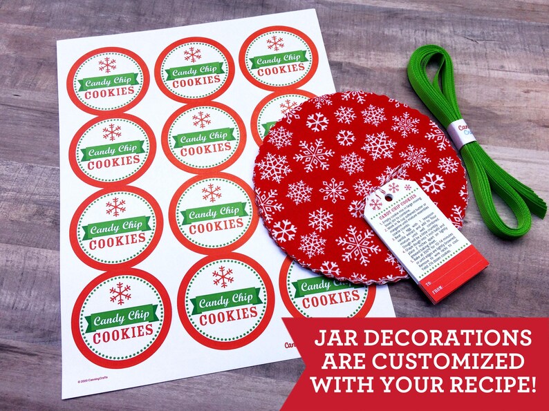 May include: A sheet of circular stickers with red borders, green banners, and snowflake icons, each labeled Candy Chip COOKIES. Includes a red fabric circle with white snowflakes, a white recipe tag, and a coil of green ribbon.