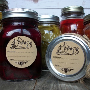 May include: A set of six glass jars with silver lids, each with a brown paper circle label featuring a black line drawing of vegetables and the words "Contents:" and "Date:".