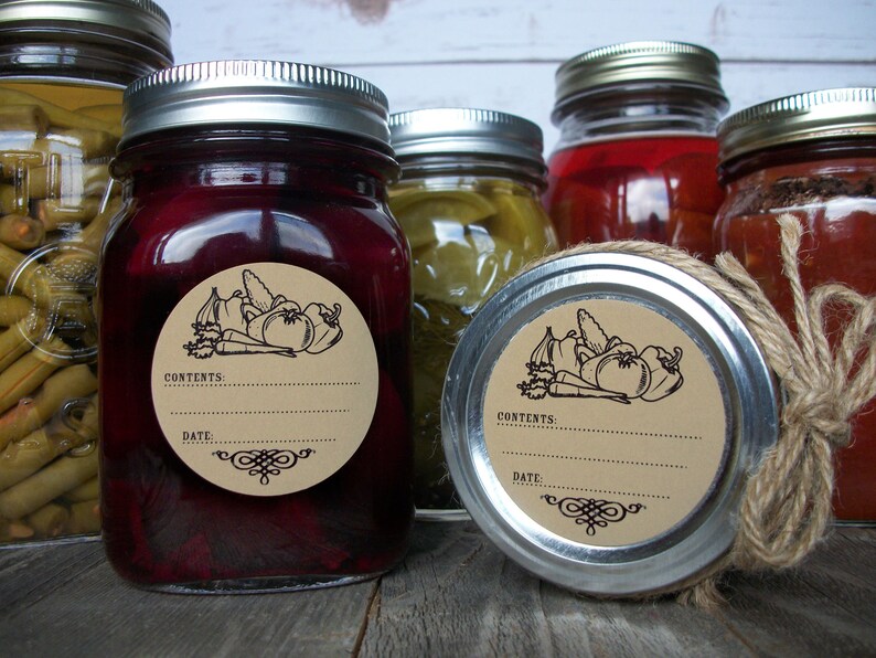 May include: A set of six glass jars with silver lids, each with a brown paper circle label featuring a black line drawing of vegetables and the words "Contents:" and "Date:".