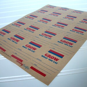 May include: A sheet of brown paper with multiple labels printed on it. Each label has the text "GROW WHAT YOU EAT" in red and blue lettering. The labels have lines for writing the date, contents, and other information.