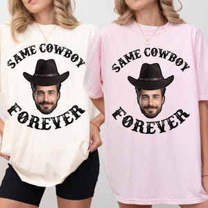 May include: Two t-shirts with the text "Same Cowboy Forever" and a cartoon cowboy wearing a hat. The t-shirt on the left is ivory and the t-shirt on the right is pink.