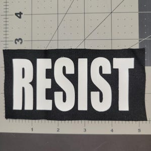 RESIST patch, vinyl on cotton canvas