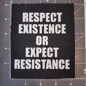 May include: Black fabric patch with white text that reads "Respect Existence or Expect Resistance".