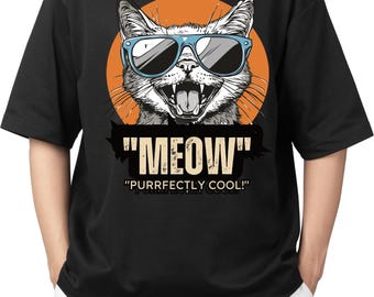 May include: Black t-shirt featuring a graphic of a cat wearing sunglasses against an orange circle. The cat's mouth is open, and the text "MEOW" and "PURRFECTLY COOL!" are displayed below the cat.