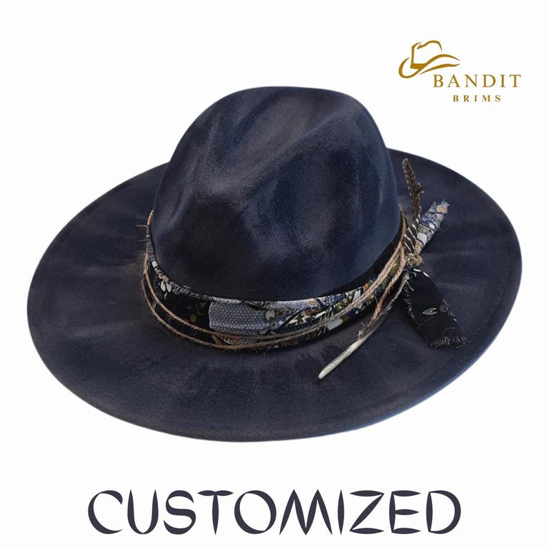 May include: A navy blue fedora hat with a wide brim. The hat features a patterned band, twine, and a feather accent. The word "CUSTOMIZED" is printed at the bottom of the image. The hat has the "BANDIT BRIMS" logo.