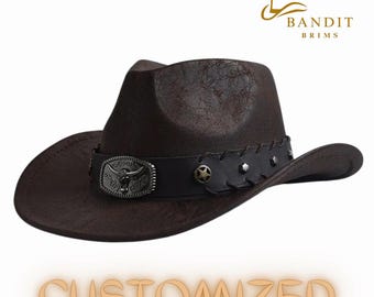May include: A brown leather cowboy hat with a black leather band, a silver star, and a silver bull's head buckle. The hat has a distressed look and is labeled "Bandit Brims" and "Customized".