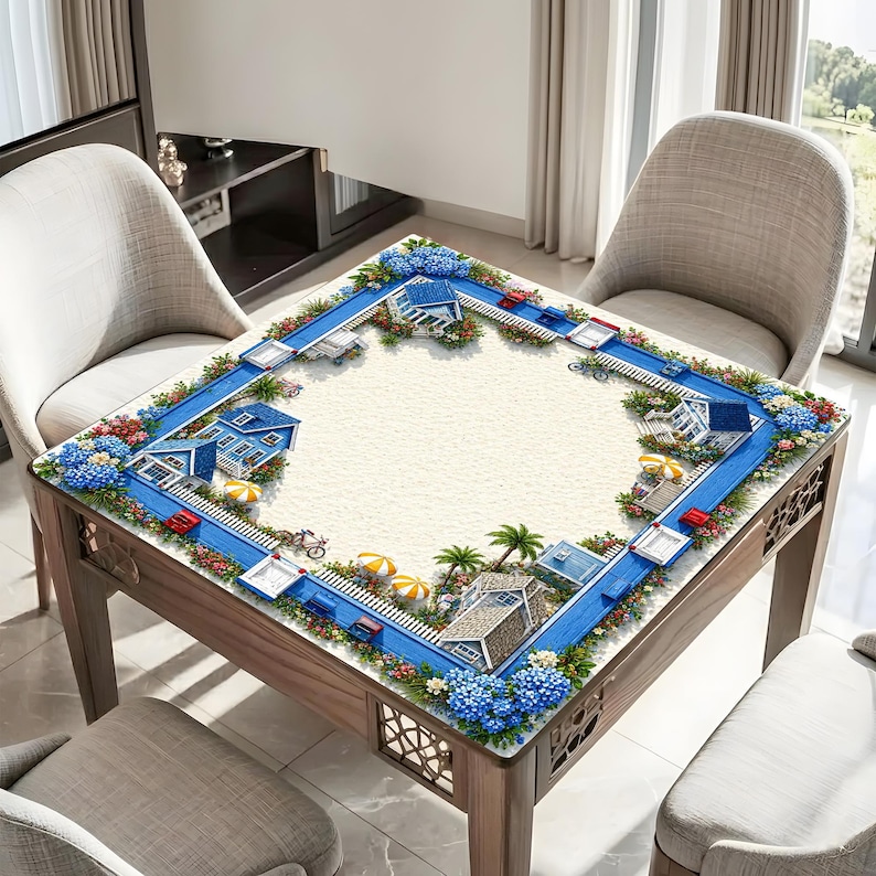 May include: Wooden square table with a decorative beach scene tabletop. The design features a blue road with miniature houses, cars, and bicycles. The edges are adorned with blue flowers and colorful floral arrangements. The table is surrounded by two chairs.