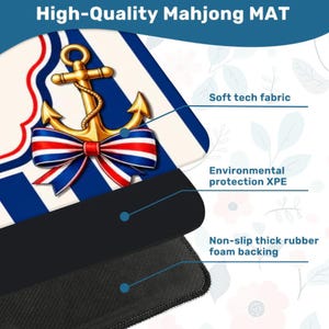 May include: A high-quality Mahjong mat featuring a gold anchor with a red, white, and blue bow. The mat has a soft tech fabric surface, environmental protection XPE, and a non-slip thick rubber foam backing. The text "High-Quality Mahjong MAT" is at the top.