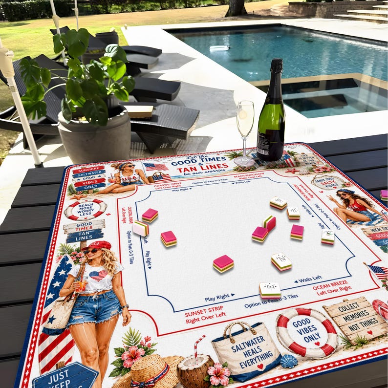 May include: A square game mat featuring a white center with game instructions and scattered colorful tiles. The border displays illustrations of a person in a red cap, a straw hat, a life preserver, and text including Let the Good Times & Tan Lines be our worries.
