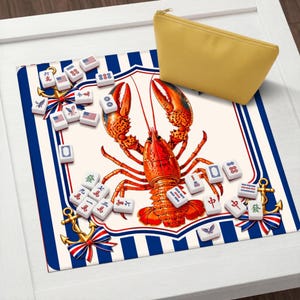 May include: A decorative Mahjong game mat featuring a vibrant red lobster illustration. The mat has a nautical theme with blue and white stripes, anchors, and Mahjong tiles. A yellow zippered pouch is in the upper right corner.