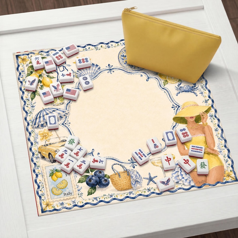 May include: A yellow zippered pouch rests on a decorative mat with a beach theme. The mat features illustrations of lemons, a convertible car, and a woman in a yellow dress. Scattered around are white Mahjong tiles with red and blue markings.