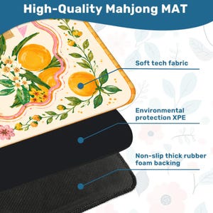 May include: A high-quality Mahjong mat with a decorative design featuring oranges and floral elements. The mat has a soft tech fabric surface, environmental protection XPE, and a non-slip thick rubber foam backing.