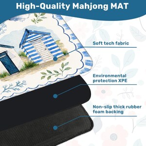 May include: A Mahjong mat featuring a watercolor illustration of blue and white beach huts with green foliage. The mat consists of three layers: a soft tech fabric top, an environmental protection XPE middle, and a non-slip thick rubber foam backing.