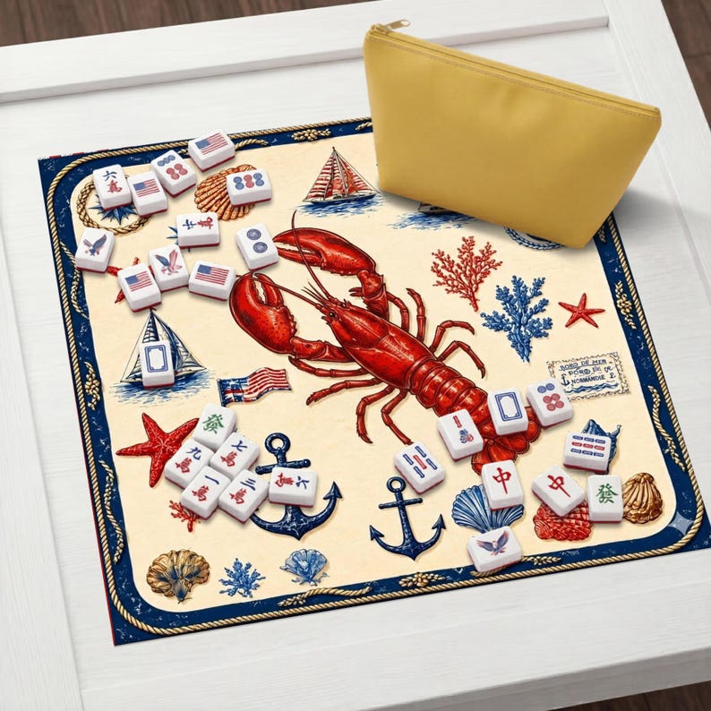 May include: A nautical-themed Mahjong set with a red lobster illustration, anchors, and seashells. The game board features a cream background with blue and red accents. A yellow zippered pouch is also included.