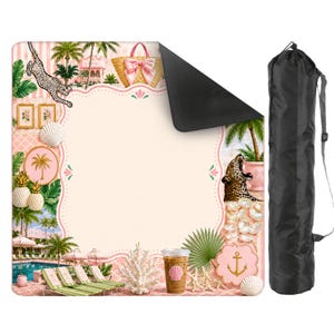 May include: A pink and white beach blanket with a tropical design featuring a leopard, palm trees, and a straw bag with a pink bow. Includes a black carrying bag with a shoulder strap.
