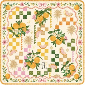 May include: Square decorative scarf with a cream background featuring orange and green checkered patterns, orange fruit illustrations, palm trees, and floral accents. The border is adorned with flowers and oranges. A pink ribbon and the letter "R" are also visible.