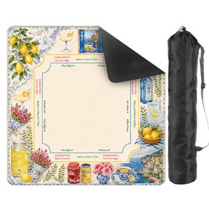 May include: A square, decorative mat with a lemon and floral design, featuring images of cocktails, lemons, and coastal scenes. Includes a black carrying bag with a shoulder strap. The mat has text that reads "Charleston" and "Italia".